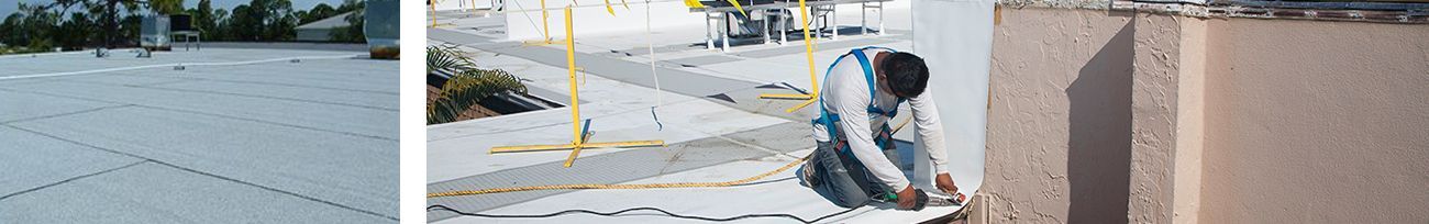 Close up of flat roof and roofer installing a flat roof.