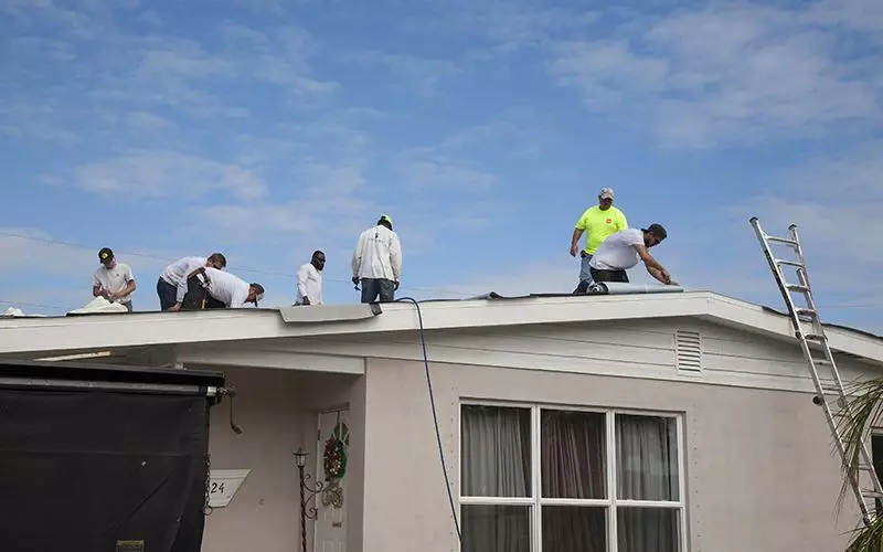 A team of Florida Southern Roofing roofers working on Mr. Bostic's roof.